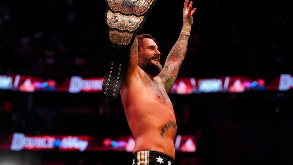 CM Punk raising the AEW World Championship