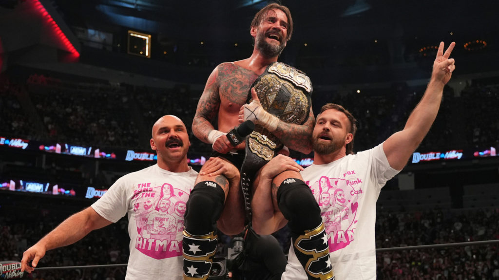 CM Punk and FTR celebrating Punk's AEW World Championship win